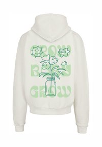 Hoodie i off-white med en grøn kontur af en blomsteropstilling i et glas, med teksten "GROW" i grønne stiliserede bogstaver.