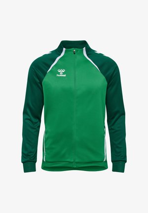 Veste de sport verte avec des accents blancs, fermeture éclair sur le devant, manches longues, fabriquée en tissu lisse, présentant un design sportif et un logo.