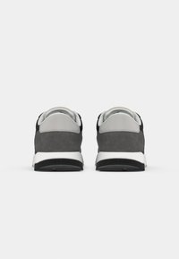 Pair of gray and black sneakers with white soles shown from the back on a plain white background.