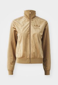 Tan Velours Sweatjacke mit hohem Kragen. Verfügt über gerippte Bündchen und Saum, seitliche Taschen und ein gesticktes Logo auf der Brust.