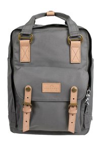 Gray canvas backpack with tan leather accents, top handles, and adjustable straps. Features a front pocket and metallic hardware.
