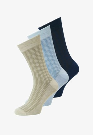 Drie paar kousen tot halverwege de kuit in beige, lichtblauw en marineblauw met een subtiele geprinte gebreide textuur.