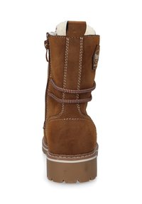 Brown suede ankle boot with white faux fur lining, contrast stitching, and a textured rubber sole. Features a rear zipper and decorative laces.