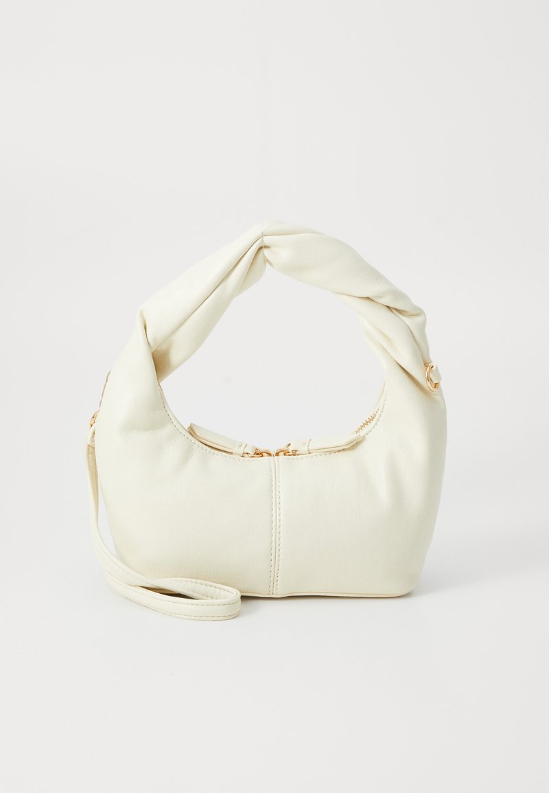 White faux leather handbag with a knotted handle, zip closure, gold hardware accents, and a rounded shape.
