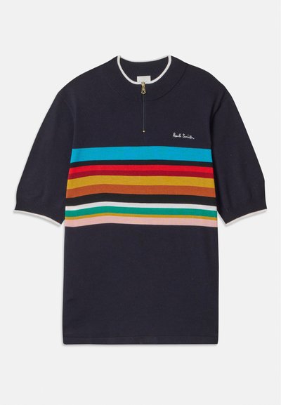Tummansininen lyhythihainen pullover, jossa on puolivetoketju-kaulus, moniväriset vaakasuorat raidat punaisena, oranssina, vihreänä ja sinisenä, valkoisilla yksityiskohdilla.