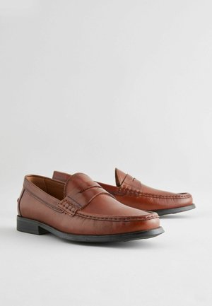 Brown leather loafers with a moccasin design, featuring stitched accents, a flat rubber sole, and a sleek, rounded toe shape.