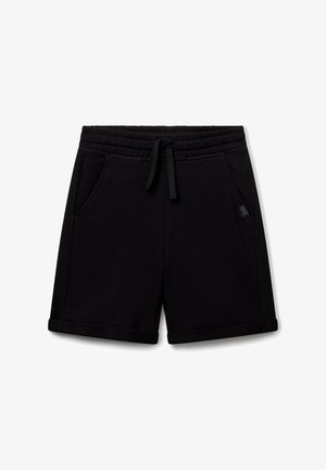 Shorts in cotone nero con vita regolabile tramite cordino, tasche laterali e una texture liscia. Presentano un orlo arrotolato e un sottile dettaglio del logo.
