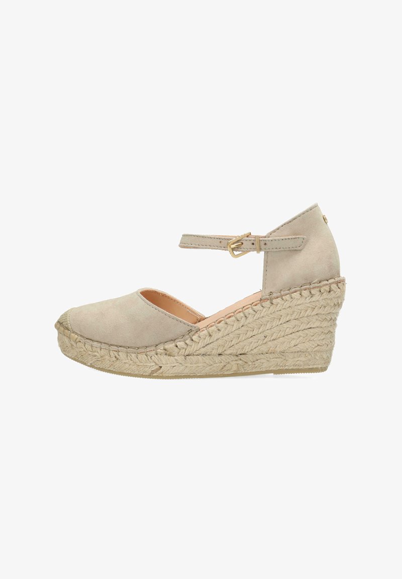 Beige suede wedge shoe with a round toe, ankle strap with buckle, and jute-wrapped heel. Features a smooth upper and textured sole.