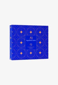 Blue rectangular box with geometric orange patterns. Features a central blue label with white and gold text. Contains skincare products.