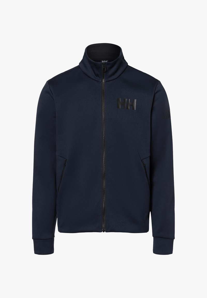 Chaqueta con cremallera en azul marino, fabricada en tejido suave, con un cuello alto, dos bolsillos laterales y un logotipo negro mate en el pecho.