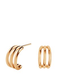 Złote kolczyki wykonane z metalu, z spiralnym wzorem składającym się z trzech zakrzywionych pasm, charakteryzujące się gładką fakturą i eleganckim kształtem koła.