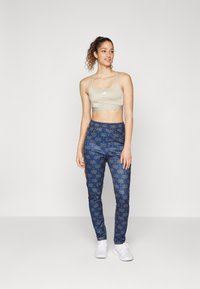 adidas Sportswear ADIDAS FARM RIO TIRO TRACK - Spodnji deli trenirk - bronze strata/dark marine/night indigo