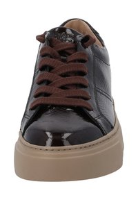 Sneakers en cuir verni noir avec lacets marron, embout arrondi et semelle plate beige. Présente une surface texturée et des accents cousus.