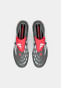 Gray athletic shoes with a textured upper, red accents, and white stripes. Features a snug fit with a streamlined design and lace closure.