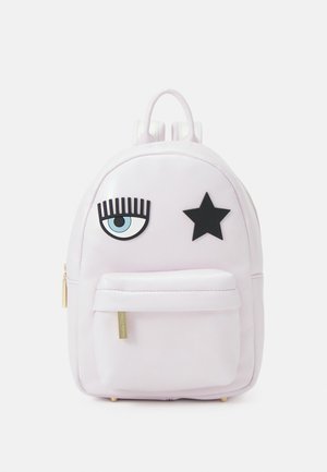 Petit sac à dos rose clair avec une poche avant, présentant un œil bleu avec des cils noirs et une étoile noire sur le compartiment principal.