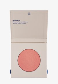 Blush compacto en un envase claro con una bandeja redonda de color rosa brillante. El texto en el embalaje incluye "Infundido con extracto de flor de peonía".