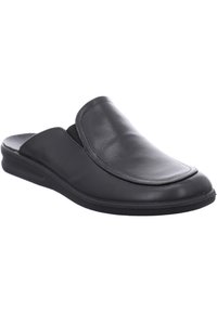 Mocassin en cuir noir avec une semelle intérieure rembourrée, un bout rond et des coutures minimalistes, doté d'une semelle extérieure en caoutchouc à profil bas.