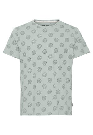 Light green short-sleeve t-shirt with a circular pattern outlined in black, featuring a round neck and soft cotton fabric.