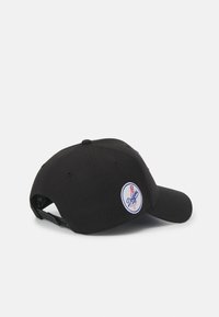 Black baseball cap with a rounded shape, featuring an embroidered blue and white logo on the side and a textured fabric surface.