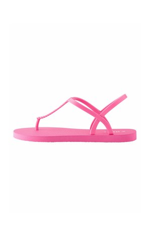 Flip-flop rosa in gomma con suola testurizzata. Presenta sottili cinturini incrociati e un leggero tacco. Design semplice, costruzione leggera.