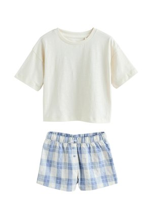 Lühikeste varrukatega kreemikas puuvillane topp, sobitatud sinise ja valge ruudulise puuvillaste pükstega, millel on elastne vöökoht ja nööbi detailid.