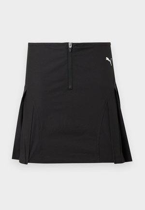 Sort atletisk skjørt med frontglidelås og sidesplitter, med en hvit Puma-logo på øvre høyre side.