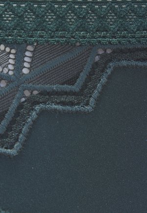 Dark teal fabric with scalloped lace trim featuring floral and geometric patterns along the edge.