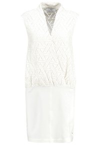 Valkoinen hihaton mekko, jossa on ylhäällä teksturoitu geometrinen kuviopinta ja alhaalla sileä valkoinen osa. Mekossa on V-kaula-aukko ja elastinen vyötärö.