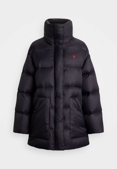Zwarte pufferjack met hoge kraag, oversized silhouet, gewatteerde secties, voorzakken en rode logoaccent op de linkerkant van de borst.