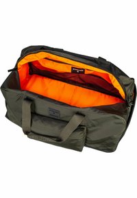 Sac de sport en nylon vert avec doublure orange, poignées renforcées et fermeture éclair. Comprend plusieurs poches intérieures pour l'organisation.