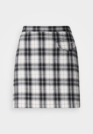 Plaid skirt features a black and white pattern with a slim fit, a straight cut, and a small back pocket for detail. Made of woven fabric.