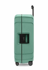 Valigia rigida color verde menta, con superficie testurizzata, manico retrattile, sistema di chiusura nero e quattro ruote nere.