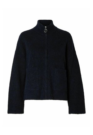 Cardigan zippé bleu marine en tissu texturé, avec un col montant, deux poches avant et un tirette de fermeture éclair circulaire.