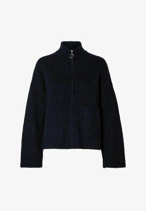 Navy zip-up cardigan made of textured fabric, featuring a high collar, two front pockets, and a circular zipper pull.