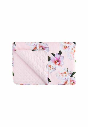 Quilted pink blanket with large white and pink floral patterns, folded to show a textured stitched backing.