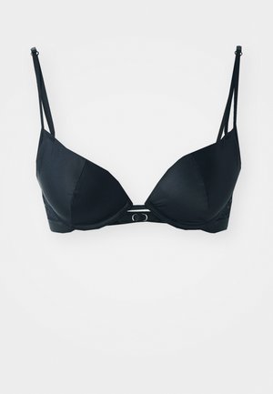 Reggiseno nero con tessuto liscio e opaco, coppe sagomate e spalline regolabili; presenta un dettaglio decorativo in metallo circolare al centro.