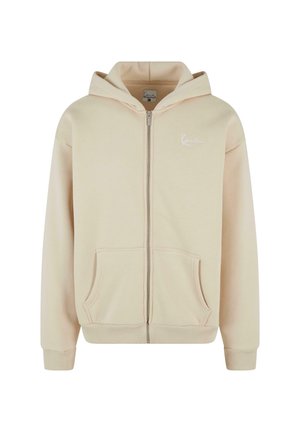 Beige zip-up hoodie with front pockets, ribbed cuffs, and waistband. Features a small white logo on the left chest area. Soft fabric texture.