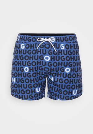 Swim shorts featuring a blue background with black and white "HUGO" text pattern, elastic waistband, and drawstring closure.