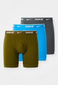 Pack of three men's boxer briefs in olive green, blue, and dark gray. Features elastic Nike logo waistband and fitted design. Smooth cotton material.