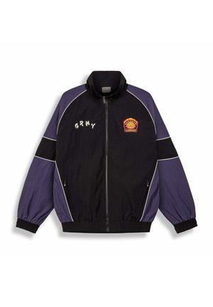 Zwarte en paarse windbreaker jas met witte piping, elastische manchetten, geborduurd "GRMY" en "Bruins Lords" logo op de borst, twee zijzakken.