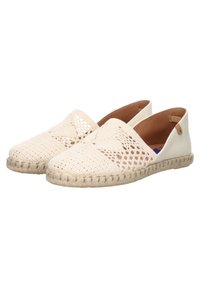 Espadrilles beige con parte superior de tejido trenzado, abierta por detrás y suela beige en contraste con acentos de yute. Diseño texturizado y transpirable.