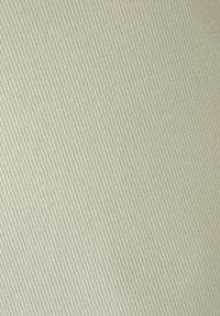 Textured fabric in soft beige with vertical ribbing, reflecting light subtly, featuring a smooth surface with a slight sheen.