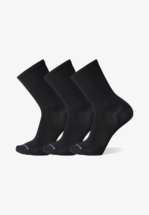 Calzini di cotone neri, texture a coste, lunghezza alla caviglia. Tre paia esposti uno accanto all'altro, con tallone e punta rinforzati, logo sulla suola.