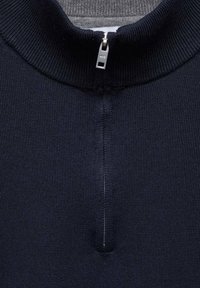 Sweatshirt zippé marine avec col côtelé et tissu texturé, doté d'une courte fermeture éclair au cou et de détails de couture subtils.