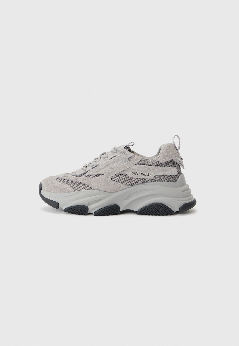 Light grey sneaker featuring a mix of suede and mesh materials, thick rubber sole, and textured accents in a darker shade.