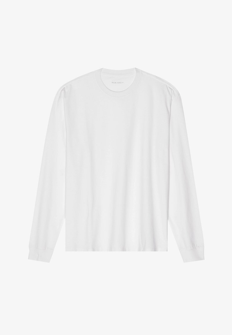 Vit långärmad t-shirt i bomull med rund hals, ribbade muddar och rak nederkant, slät textur och minimalistisk design.