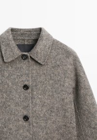 Gray wool-blend coat with a structured collar, two black buttons, and a textured finish. Includes side pockets and minimalist design.