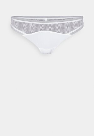 White thong with a sheer, patterned gray mesh waistband. Smooth fabric, minimalist design, no visible hardware or accents.