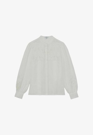 Bílá halenka s dlouhým rukávem s květinovou výšivkou na hrudi a rukávech, zapínání na knoflíky vpředu a manžety na zápěstích.