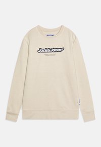 Felpa beige con collo rotondo, maniche lunghe e polsini a costine, caratterizzata da un logo nero ben visibile sul davanti. Tessuto morbido, design casual.